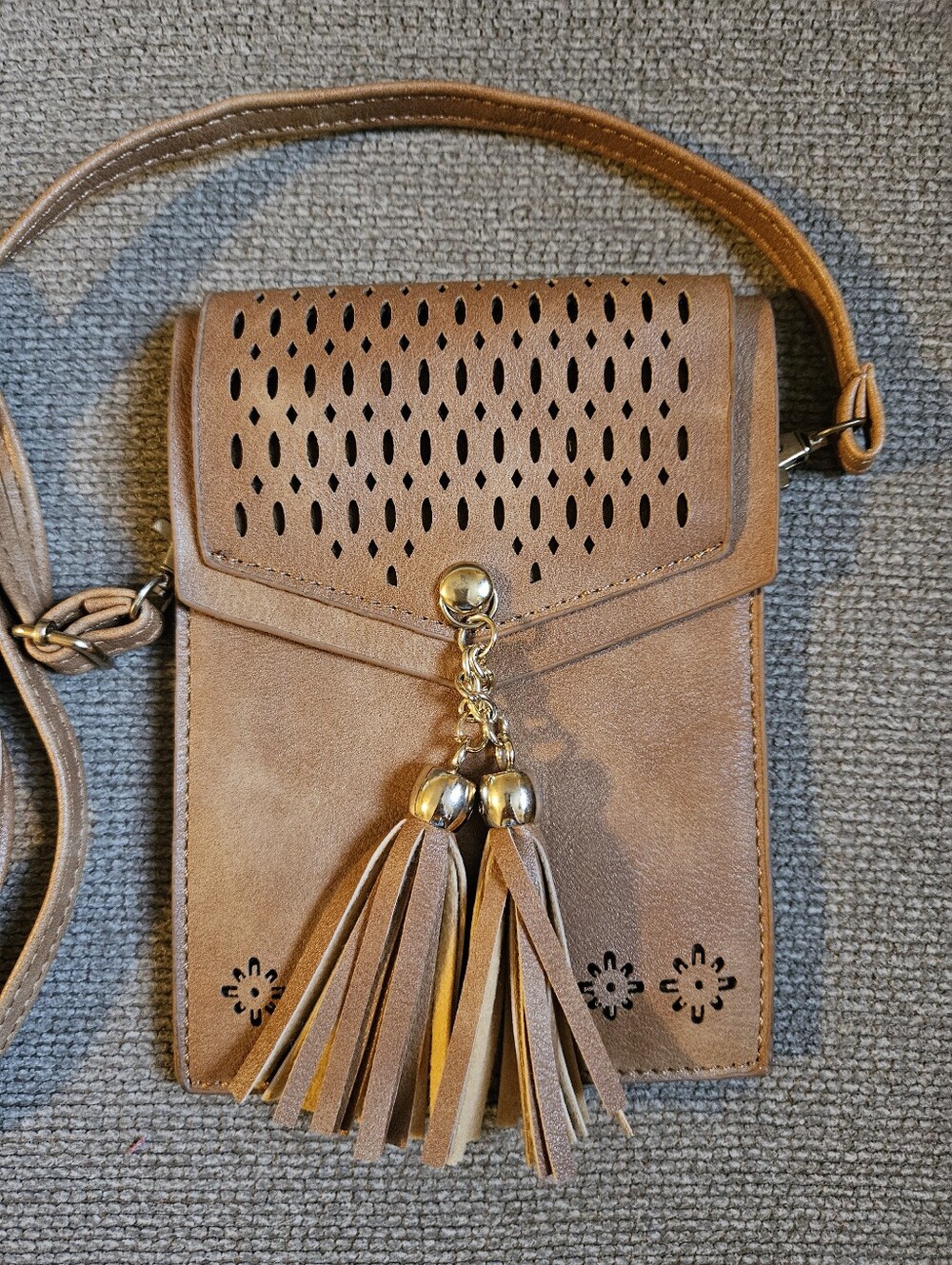 Brown faux leather cell phone crossbody bag with tassels & laser-cut pattern